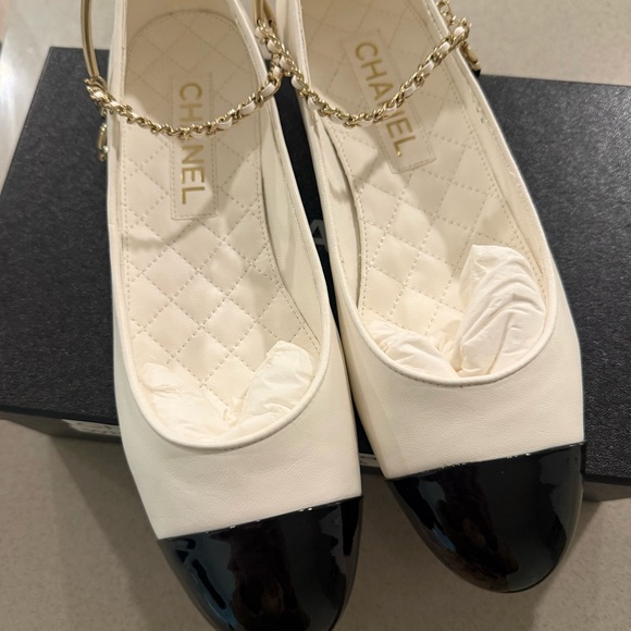 CHANEL Shoes - CHANEL Cream Leather Flats with Black Patent Cap-Toe and Gold Chain Strap